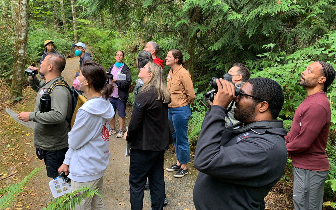 Rising Star Elementary staff looking and listening for birds in IslandWood