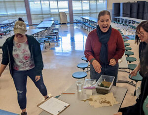 Teachers participating in a beach erosion mitigation activity