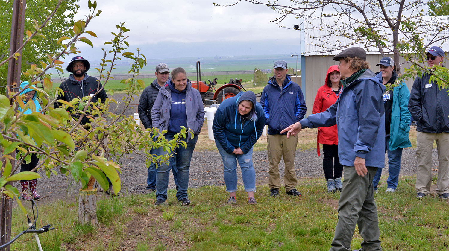 Farmer Jim Baird teaches participants about techniques for apple propagation.
