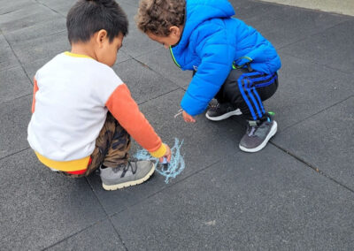 Students drawing what they found with chalk.