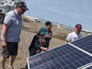 Participants examine solar panels up close.