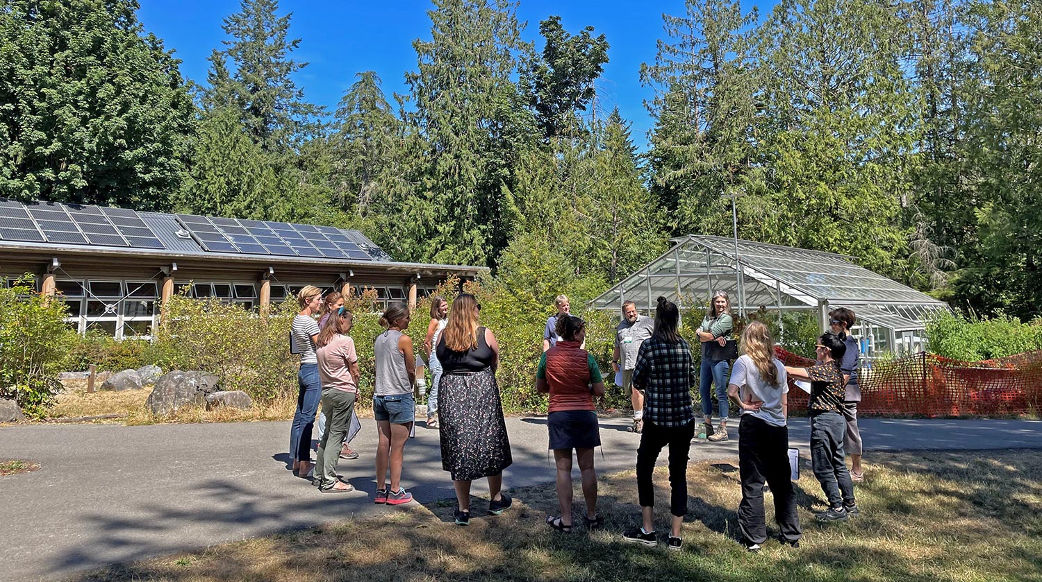 Localize Amplify Working Group members gather outside at the IslandWood Bainbridge campus