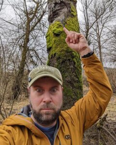 Reflecting on river rising patterns: Kent Chapple, Oxbow Farm Education Program Manager, shows teachers 10-foot-high beaver chew markings